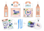 Load image into Gallery viewer, A Kuwi Kiwi Tiny Tūī air dry clay kit shown with its retail packaging, instruction sheet, blue plastic tools, and a round palette of clay colours on a white background.